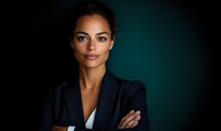 Confident mixed race businesswoman in dark blazer with crossed arms against dramatic teal background, professional corporate portrait with moody lighting.