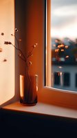 Minimalist dried branch in amber glass vase on windowsill at sunset, casting warm shadows against wall. Natural light creates cozy atmospheric mood.