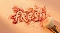 Fresh cosmetic powder scattered with makeup brush on warm peachy background, suitable for beauty, cosmetics, skincare marketing and product promotion designs.