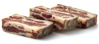 Raw pork belly slices with layers of meat and fat, fresh cut showing marbling pattern on white background, isolated for culinary and food industry use.