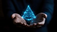 Glowing blue holographic pyramid floating above cupped hands against dark background, magical light particles and sparkles creating ethereal atmosphere.