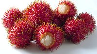 Fresh ripe rambutan fruits with bright red spiky skin and sweet white flesh visible through opened shells on white background, ready for healthy eating.