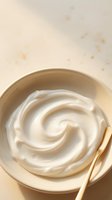 Creamy white swirl texture in wooden bowl with spoon for skincare cosmetics and natural beauty product applications.