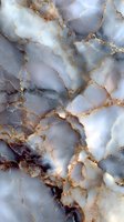 Luxurious marble texture with golden veins and soft gray tones for elegant interior design and sophisticated backgrounds.