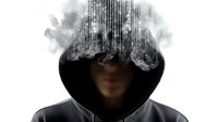 Mysterious hooded figure with digital matrix code dissolving head effect, representing cybersecurity threat and digital identity theft in modern technology era.