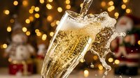 Champagne pouring into glass with sparkling bubbles and golden bokeh lights in background, celebration and festive party atmosphere for holiday events and toasts.