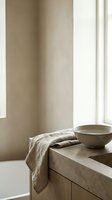 Minimalist bathroom corner with natural light from window, wooden vanity, ceramic bowl, and folded linen towel for spa, wellness, and interior design projects.