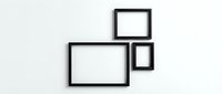 Three black empty picture frames arranged on a white wall, mockup for art display, gallery wall decor, and interior design presentation.