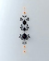 Elegant black floral wall sconce with glowing orange lights creates dramatic contrast against white wall, combining modern lighting with nature-inspired design elements.