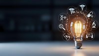 Glowing light bulb with medical healthcare icons floating around representing innovation in medicine and digital health technology solutions.