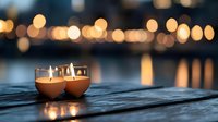 Lit candles on wooden surface with blurred bokeh lights in background, suitable for relaxation, meditation, wellness, and spa design projects.
