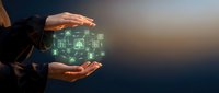 Businessperson holding glowing digital network icons between hands, representing connectivity, data exchange, and technology solutions for corporate growth.