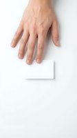 Male hand with fair complexion holding blank white card on white background, suitable for business, marketing, and promotional design projects.