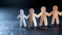 Paper cutout figures holding hands in unity against blue background, symbolizing community, teamwork and social connection. Gradient lighting creates depth and mood.