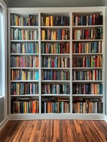 Large white built-in bookshelf filled with colorful books in modern home library interior with hardwood floors for reading and education concepts.