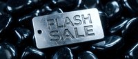 Metal tag with Flash Sale text on shiny black stones, dramatic dark tones, retail promotion concept for banners, ads, and marketing campaigns.