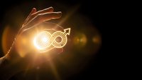 Glowing infinity symbol with upward arrow held in hand against dark background, representing growth, success, and unlimited potential for business concepts.