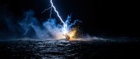 Dramatic lightning strike hitting turbulent ocean waters creating explosive splash with glowing sparks and storm clouds in dark night sky for weather concepts.