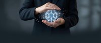 Businessman holding glowing digital network sphere with connected nodes, representing technology, data connectivity, and global communication for business solutions.
