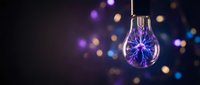 Glowing lightbulb with purple electric filament against blurred bokeh background, representing innovation, energy, and creative ideas for design projects.