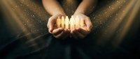 Hands holding glowing WWW letters with magical sparkles and golden light rays, representing internet connectivity and digital communication technology.