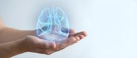 Human hands holding glowing blue lungs hologram representing respiratory health, medical technology and healthcare innovation for wellness concepts.