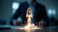 Glowing orange rocket launch icon emerging from business desk with sparkles and smoke effects against dark background, symbolizing startup and business growth.