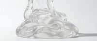 Transparent gel or clear liquid substance pooling on white surface with dropper above, isolated on white background for design, cosmetics, skincare, and product packaging applications.