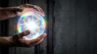 Hands protecting glowing rainbow energy sphere with bright light rays against dark concrete wall background for spiritual healing concepts.