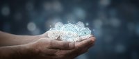 Hands holding glowing digital brain with neural network connections representing artificial intelligence and machine learning technology concepts.