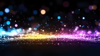 Magical glowing particles with colorful bokeh lights floating in dark space, sparkling abstract background with blue, pink and golden light effects.
