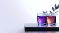 Colorful cocktails in glasses with galaxy effect and plant shadow on light background, modern mixology concept for bars and restaurants.
