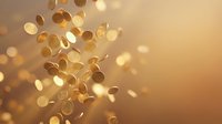 Golden coins falling through warm bokeh light creating magical wealth and prosperity atmosphere for financial success concepts.