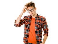 Young confused Caucasian man in glasses and plaid shirt scratching head with puzzled expression isolated on white background for design projects.