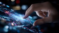 Futuristic touch interface with glowing digital particles and human hand interaction, displaying innovative technology against dark background with bokeh effects.