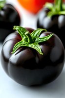 Fresh ripe black tomato with green stem and leaves in macro photography showing detailed texture and natural water drops on dark glossy surface.