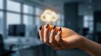 Female hand holding glowing infinity symbol in modern office space representing endless possibilities, innovation and business growth concepts.