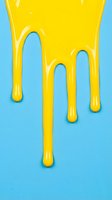 Bright yellow liquid dripping down from top onto light blue background, creating glossy drips and puddles. Use for cosmetics, food, beverage, or creative design projects.