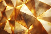 Abstract geometric background with golden triangular shapes creating dimensional surface pattern. Metallic luxury texture with light reflections and shadows.
