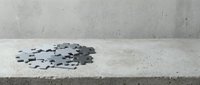 Scattered black puzzle pieces on concrete surface creating mystery and problem-solving concept for business presentations and educational materials.