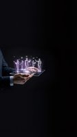 Businessman holding tablet with holographic team figures emerging from screen representing digital workforce management and virtual collaboration technology.
