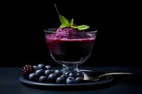 Blueberry dessert with fresh berries and mint garnish on dark elegant background for gourmet food photography and culinary presentations.