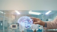 Professional businessman holding holographic brain model with digital network connections in modern medical laboratory for artificial intelligence research.