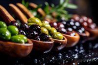 Assorted olives in wooden spoons on dark surface with herbs, Mediterranean appetizer selection for gourmet cooking and culinary presentations.