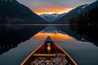 Wooden canoe bow with glowing lantern and cozy blanket on calm mountain lake at sunset, dramatic orange sky reflecting in dark water between snow peaks.