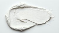 Thick white cream or paste texture isolated on white background, suitable for cosmetics, skincare, beauty product mockups, and design applications.