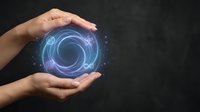 Hands protecting glowing blue energy sphere with swirling patterns on dark background representing innovation, technology protection and digital transformation.