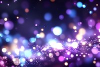 Purple bokeh lights background with sparkling glitter effects and colorful light spots creating magical atmosphere for festive celebrations and events.