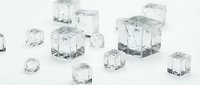 Transparent ice cubes of various sizes scattered on white background, ready for beverage, food, and design applications.