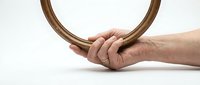 Hand holding wooden embroidery hoop on white background, crafting supplies for needlework and sewing projects, isolated design element for DIY tutorials.